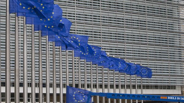 Workers adjust the EU flags in front of EU headquarters in Brussels. (File) - Sputnik International