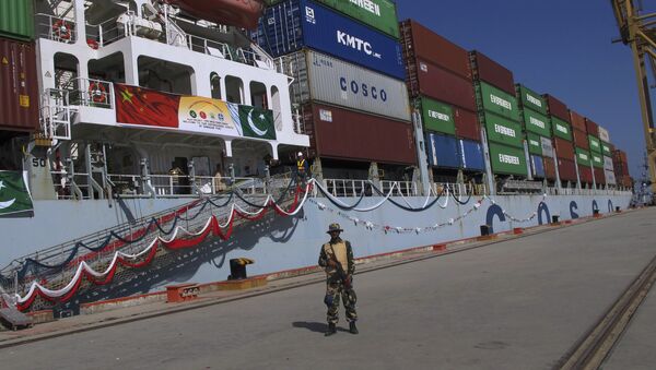 A Pakistan Navy soldier stands guard while a loaded Chinese ship prepares to depart, at Gwadar port, about 700 kilometers (435 miles) west of Karachi. Pakistan, Sunday, Nov. 13, 2016. - Sputnik International