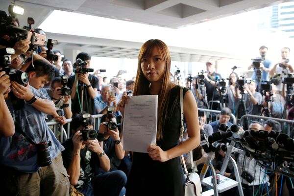 Democratically-elected legislators Yau Wai-ching holds the judgement as she leaves the High Court after court rules pro-independence lawmakers barred in Hong Kong, China November 15, 2016. - Sputnik International