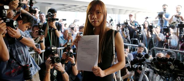 Democratically-elected legislators Yau Wai-ching holds the judgement as she leaves the High Court after court rules pro-independence lawmakers barred in Hong Kong, China November 15, 2016. Democratically-elected legislators Yau Wai-ching holds the judgement as she leaves the High Court after court rules pro-independence lawmakers barred in Hong Kong, China November 15, 2016. - Sputnik International