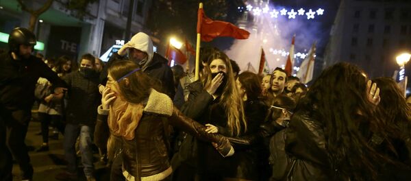 Protesters run away from teargas as they clash with riot police during a demonstration against the visit of U.S President Barack Obama, in Athens, Greece Protesters run away from teargas as they clash with riot police during a demonstration against the visit of U.S President Barack Obama, in Athens, Greece - Sputnik International