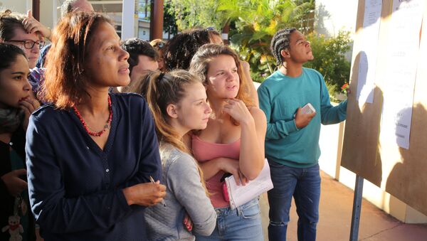Students look at a board displaying the results of the baccalaureat exam (high school graduation exam) on July 5, 2016 at the Moulin Joli high school in La Possession, in the French overseas department of La Reunion - Sputnik International