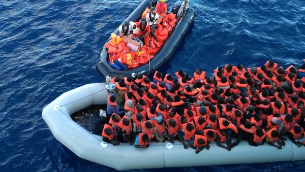 Migrants in a dinghy are rescued by the vessel Burbon Argos, run by Doctors Without Borders organization, in the Mediterranean sea, Friday, Nov. 4, 2016 - Sputnik International