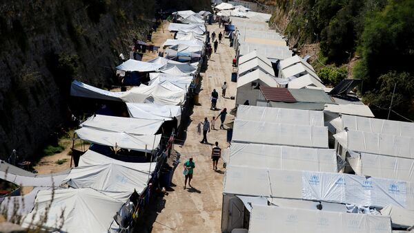 Refugees and migrants make their way at the Souda municipality-run camp, on the island of Chios, Greece, September 7, 2016 - Sputnik International