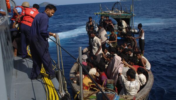 Members of the Indian coastguard rescue illegal Bangladeshi migrants in their trawler after they were sighted by the Coast Guard Aircraft off Chidiyatapu Island in the southern Andaman Islands on January 8, 2009 - Sputnik International