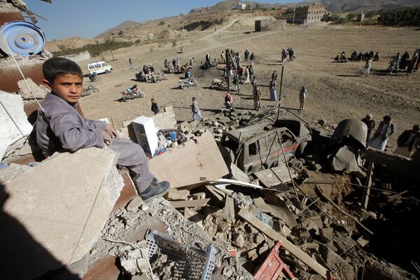 A boy looks at the camera as he sits on the wreckage of a house destroyed by a Saudi-led air strike on the outskirts of Sanaa, Yemen, November 13, 2016 A boy looks at the camera as he sits on the wreckage of a house destroyed by a Saudi-led air strike on the outskirts of Sanaa, Yemen, November 13, 2016 - Sputnik International