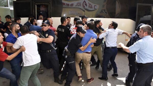 Police officers try to stop people attacking a judge believed to be member of a coup plotter group in Erzurum, Turkey, Tuesday, July 19, 2016 - Sputnik International