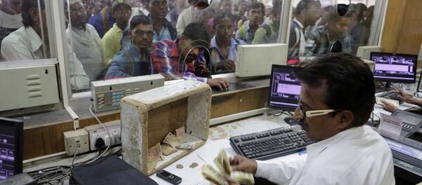 An Indian Railways staff counts currency notes of 500 denomination at a ticket counter, one of the few places still accepting the high denomination notes, in Allahabad, India , Wednesday, Nov. 9, 2016 An Indian Railways staff counts currency notes of 500 denomination at a ticket counter, one of the few places still accepting the high denomination notes, in Allahabad, India , Wednesday, Nov. 9, 2016 - Sputnik International