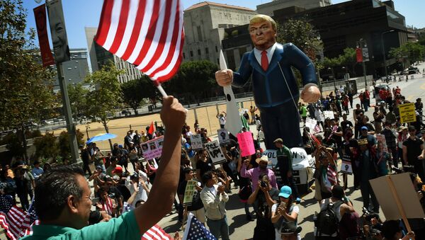This file photo taken on May 01, 2016 shows Members of the 'Full Rights for Immigrants Coalition' displaying a giant effigy of US Republican Party presidential hopeful Donald Trump during a protest on May Day in Los Angeles, California on May 1, 2016 - Sputnik International