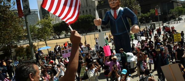 This file photo taken on May 01, 2016 shows Members of the 'Full Rights for Immigrants Coalition' displaying a giant effigy of US Republican Party presidential hopeful Donald Trump during a protest on May Day in Los Angeles, California on May 1, 2016 This file photo taken on May 01, 2016 shows Members of the 'Full Rights for Immigrants Coalition' displaying a giant effigy of US Republican Party presidential hopeful Donald Trump during a protest on May Day in Los Angeles, California on May 1, 2016 - Sputnik International
