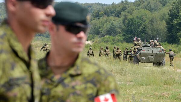 Canadian military instructors look on during Ukrainian military exercises at the International Peacekeeping and Security Center in Yavoriv, near Lviv(File) - Sputnik International