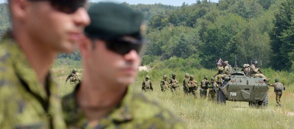 Canadian military instructors look on during Ukrainian military exercises at the International Peacekeeping and Security Center in Yavoriv, near Lviv(File) - Sputnik International