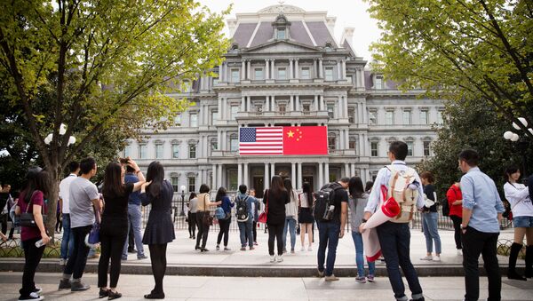 China's flag is displayed next to the American flag on the side of the Old Executive Office Building on the White House complex in Washington (File) - Sputnik International
