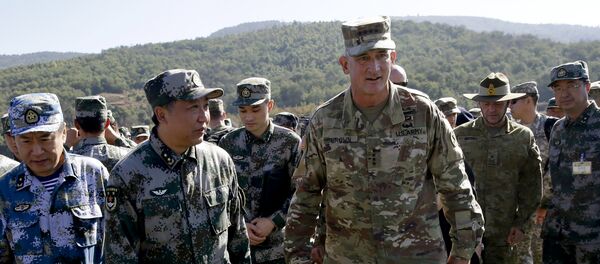 U.S. Army Pacific commander Gen. Robert Brown, center right, and Gen. Liu Xiaowu, center left, the commander for Southern Theater Command Army of Chinese Liberation Army (PLA), inspect a rescue operation venue for the U.S.-China Disaster Management Exchange (DME) drill at a PLA's training base in Kunming, southwestern China's Yunnan Province, Friday, Nov. 18, 2016 - Sputnik International