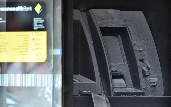 An electronic cash machine is burned at a branch of the Commonwealth Bank after a fire injured customers in Melbourne, Australia November 18, 2016 - Sputnik International