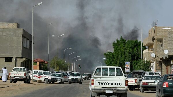 Smoke rises from a road in the district of Gardah in the southern Libyan town of Sabha (File) - Sputnik International