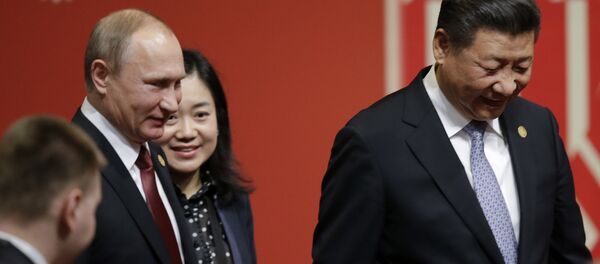Russia's President Vladimir Putin, left, and China's President Xi Jinping, leave after a meeting with business leader during the annual Asia Pacific Economic Cooperation, APEC, Summit in Lima, Peru, Saturday, Nov. 19, 2016. - Sputnik International