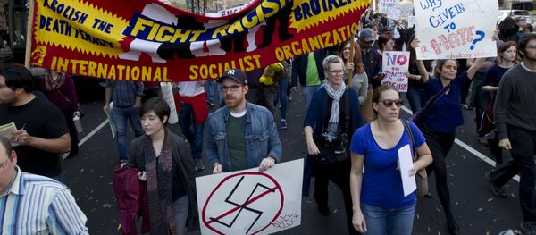 Demonstrators holds a banner as they protest in Pennsylvania Avenue outside of the Trump Hotel in Washington in opposition of President-elect Donald Trump, on Saturday, Nov. 19, 2016. Demonstrators holds a banner as they protest in Pennsylvania Avenue outside of the Trump Hotel in Washington in opposition of President-elect Donald Trump, on Saturday, Nov. 19, 2016. - Sputnik International