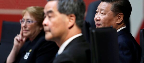 Chile's President Michelle Bachelet (L), China's President Xi Jinping (R) and Hong Kong Chief Executive Leung Chun-ying sit together during the APEC (Asia-Pacific Economic Cooperation) Summit in Lima, Peru Chile's President Michelle Bachelet (L), China's President Xi Jinping (R) and Hong Kong Chief Executive Leung Chun-ying sit together during the APEC (Asia-Pacific Economic Cooperation) Summit in Lima, Peru - Sputnik International