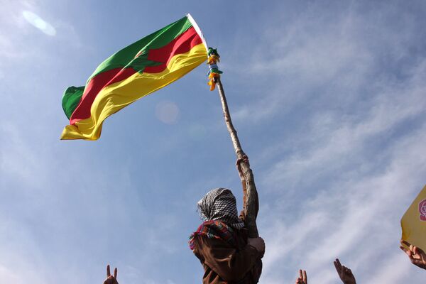 A masked Kurdish man waves a PKK's flag  - Sputnik International