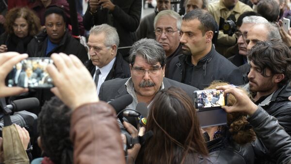 Salih Muslim Muhammad chairman of the PYD, the Syrian branch of the PKK answers journalists' questions as he arrives to pay tribute to the victims of the attacks claimed by Islamic State which killed at least 129 people and left more than 350 injured, on November 17, 2015 in front of the Bataclan theatrein Paris. (File) - Sputnik International