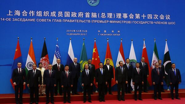 Russian Prime Minister Dmitry Medvedev, first row fifth left, during joint photo opportunity with SCO heads of government and heads of delegations of observer states. (File) - Sputnik International