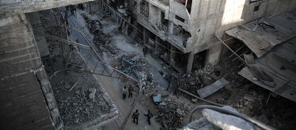 Syrians walk on a heavily damaged street in the rebel-held town of Douma, on the eastern outskirts of the capital Damascus Syrians walk on a heavily damaged street in the rebel-held town of Douma, on the eastern outskirts of the capital Damascus - Sputnik International