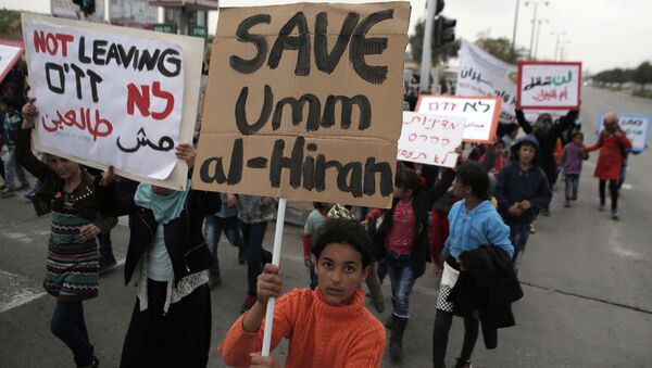 Bedouins hold placards during a protest against a plan to uproot the Umm Al-Hiran village, which is not recognized by the Israeli government, in the southern Israeli city of Beersheva in the Negev desert (File) - Sputnik International