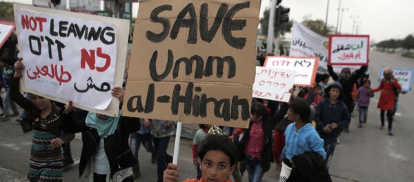 Bedouins hold placards during a protest against a plan to uproot the Umm Al-Hiran village, which is not recognized by the Israeli government, in the southern Israeli city of Beersheva in the Negev desert (File) - Sputnik International