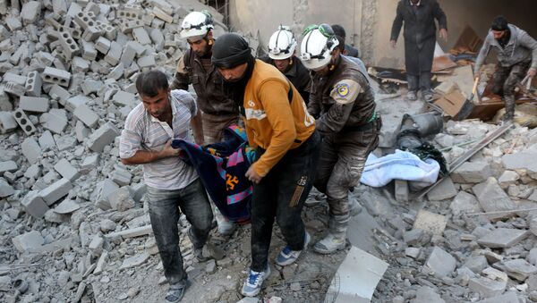Syrian civil defence volunteers, known as the White Helmets, evacuate a victim from the rubble of a building following reported airstrikes on Aleppo's rebel-held district of al-Hamra on November 20, 2016 - Sputnik International
