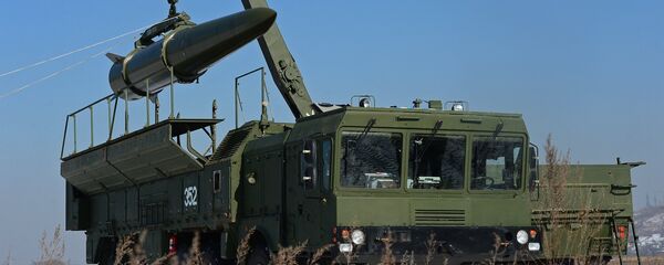 A transporter-loader places an Iskander-M shorter-range missile onto a self-propelled launcher A transporter-loader places an Iskander-M shorter-range missile onto a self-propelled launcher - Sputnik International
