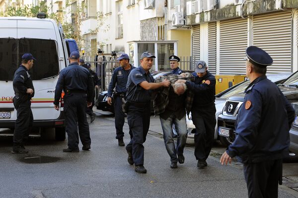 A man is escorted by Montenegrin police officers to the special court in Podgorica on October 16, 2016 - Sputnik International