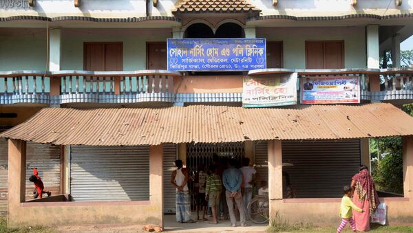 In this photograph taken on November 23, 2016, local residents stand in front of the home of alleged fake doctor, Poly Byapari, who was associated with the Sohan Nursing Home and Poly Clinic, in Habra, around 50 kms west of Kolkata - Sputnik International