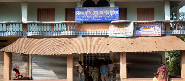 In this photograph taken on November 23, 2016, local residents stand in front of the home of alleged fake doctor, Poly Byapari, who was associated with the Sohan Nursing Home and Poly Clinic, in Habra, around 50 kms west of Kolkata In this photograph taken on November 23, 2016, local residents stand in front of the home of alleged fake doctor, Poly Byapari, who was associated with the Sohan Nursing Home and Poly Clinic, in Habra, around 50 kms west of Kolkata - Sputnik International