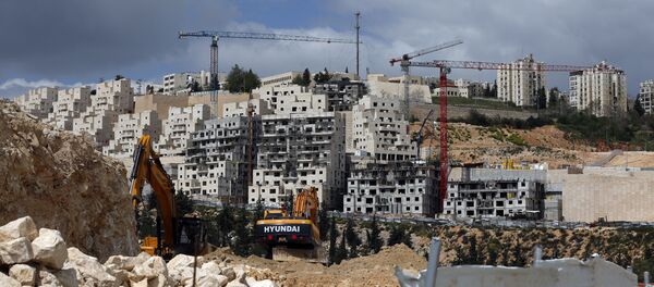 A general view taken on March 29, 2016 shows Israeli construction cranes and excavators at a building site of new housing units in the Jewish settlement of Neve Yaakov, in the northern area of east Jerusalem A general view taken on March 29, 2016 shows Israeli construction cranes and excavators at a building site of new housing units in the Jewish settlement of Neve Yaakov, in the northern area of east Jerusalem - Sputnik International
