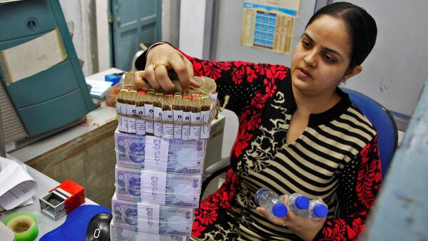 A cashier stacks Indian currency notes inside a bank in Chandigarh, India, November 19, 2016 - Sputnik International