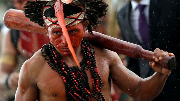 An indigenous man from the Pataxo tribe attends a protest of indigenous people at the entrance of the Planalto Palace in Brasilia - Sputnik International