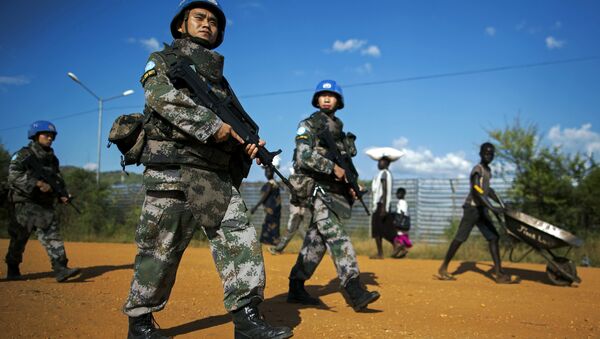 Peacekeeping troops from China, deployed by the United Nations Mission in South Sudan (UNMISS), patrol outside the premises of the UN Protection of Civilians (PoC) site in Juba on October 4, 2016 - Sputnik International