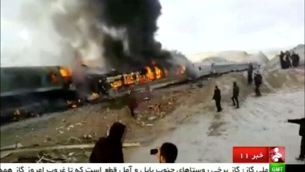 People gather around two passenger trains that collided in the city of Shahroud, in the north-central province of Semnan, killing several people, in this still frame taken from video, November 25, 2016 - Sputnik International