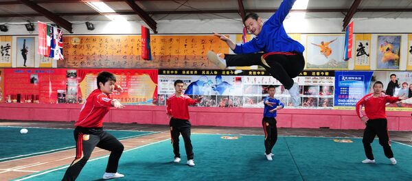 Martial arts students at a Kung fu school in the northern suburbs of Beijing practice their technique leaping over a soccer ball (File) Martial arts students at a Kung fu school in the northern suburbs of Beijing practice their technique leaping over a soccer ball (File) - Sputnik International