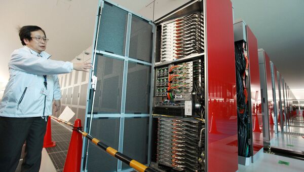 A staff member of Japan's national Riken institute opens a rack of the world's fastest supercomputer named the K Computer at Riken's laboratory in Kobe city in Hyogo prefecture, western Japan on June 21, 2011 - Sputnik International