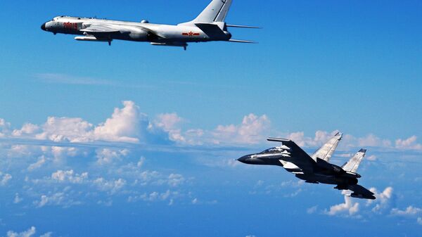 Chinese People's Liberation Army Air Force Su-30 fighter, right, flies along with a H-6K bomber as they take part in a drill near the East China Sea (File) - Sputnik International