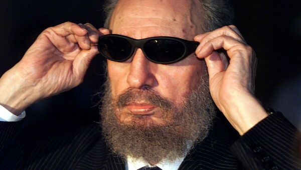 (FILES) This file photo taken on November 16, 1999 shows Cuban president Fidel Castro trying on a pair of sunglasses as he talks to the media 16 November 1999 in Havana, during the IX Iberoamerican Summit. Cuban revolutionary icon Fidel Castro died late Friday in Havana, his brother, President Raul Castro, announced on national television - Sputnik International