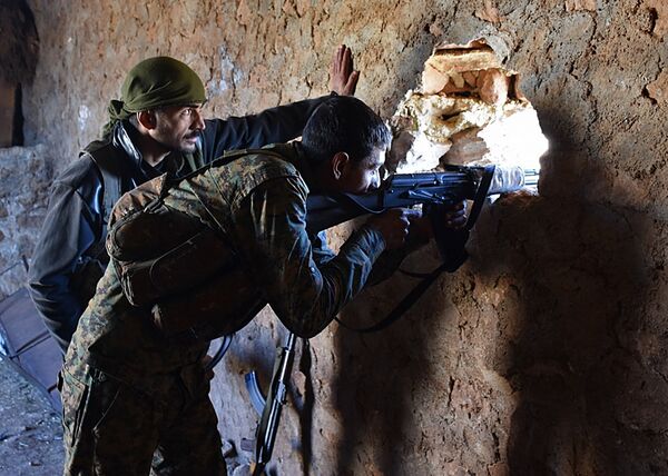 A fighter from the Syrian pro-government forces mans a riffle inside a damaged house in the recently recaptured village of Joubah during an offensive towards the area of Al-Bab in Aleppo province, on November 25, 2016 A fighter from the Syrian pro-government forces mans a riffle inside a damaged house in the recently recaptured village of Joubah during an offensive towards the area of Al-Bab in Aleppo province, on November 25, 2016 - Sputnik International
