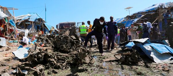 Explosive experts assess the wreckages of destroyed cars at the scene of an explosion at a police checkpoint near the vegetable market in Waberi district of Somali capital Mogadishu, November 26, 2016 - Sputnik International