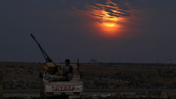 A Free Syrian army fighter sits on a pick-up truck mounted with a weapon, as the supermoon partly covered by clouds is seen in the background, in the west of the rebel-held town of Dael, in Deraa Governorate, Syria November 14, 2016 - Sputnik International