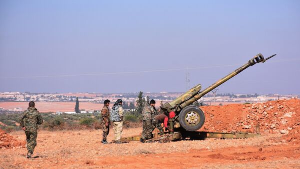 Syrian pro-government fighters fire a Russian 122mm howitzer gun as they advance in the recently recaptured village of Joubah during an offensive towards the area of Al-Bab in Aleppo province, on November 25, 2016 - Sputnik International