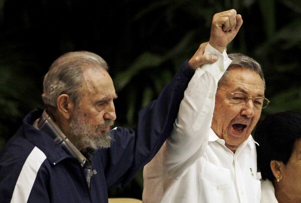 Fidel Castro, left, raises his brother's hand, Cuba's President Raul Castro, center, as they sing the anthem of international socialism during the 6th Communist Party Congress in Havana, Cuba (File) Fidel Castro, left, raises his brother's hand, Cuba's President Raul Castro, center, as they sing the anthem of international socialism during the 6th Communist Party Congress in Havana, Cuba (File) - Sputnik International