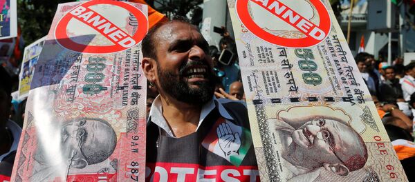 A man holds placards and shouts slogans during a rally organized by India's main opposition Congress party against the government's decision to withdraw 500 and 1000 Indian rupee banknotes from circulation, in Mumbai, India November 28, 2016. A man holds placards and shouts slogans during a rally organized by India's main opposition Congress party against the government's decision to withdraw 500 and 1000 Indian rupee banknotes from circulation, in Mumbai, India November 28, 2016. - Sputnik International