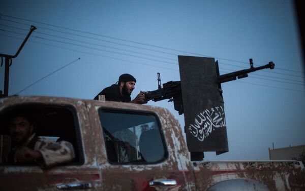 A member of Ahrar al-Sham fires against a position of the Committees for the Protection of the Kurdish People (YPG) during clashes in the countryside of the northern Syrian Raqqa province on August 25, 2013. - Sputnik International